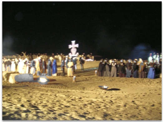 The illuminated Camargue Cross of Les Saintes Maries de la Mer  is carried into the evocation