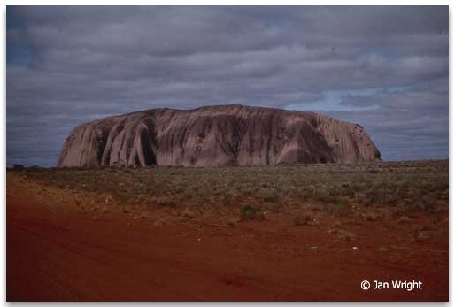 Photo of Ayers Rock taken around midday with no shadow on the Rock