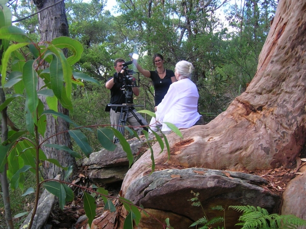 Valerie Barrow with film crew, under the grandmother tree at Kariong