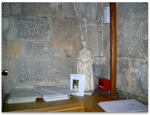A Dominican monk overlooks the menu in the dining room of the Royal Convent