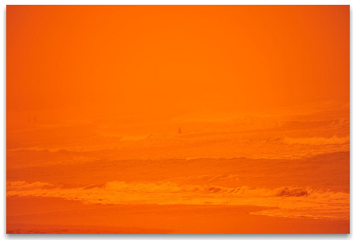 The Red Beach with a lone swimmer in the dust storm