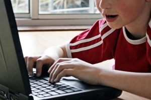 Child works on a laptop computer