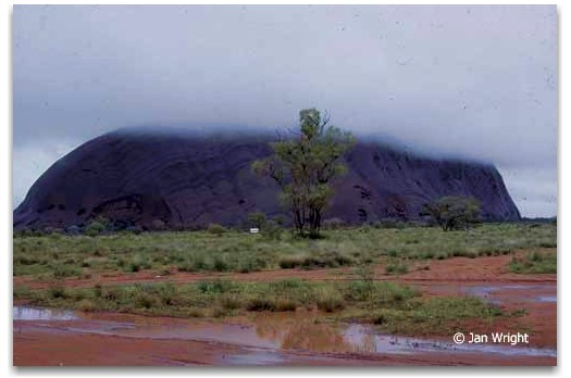 Photo of Ayers Rock - Uluru taken from the Ansett Lodge - storm clouds hide the top of the Rock