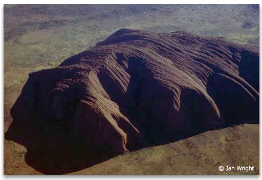 View of Ayers Rock from the air showing striations across the top of the rock